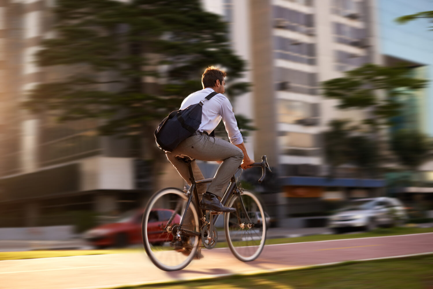 Shot of a young man on his morning bicycle commute to work